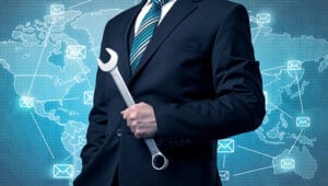 Professional website designer holding a wrench, symbolizing technical support and web development se.